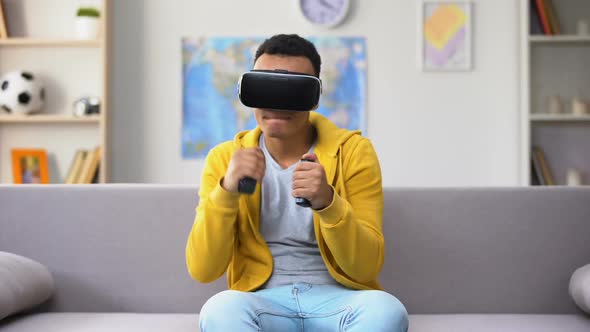 African-American Male Teenager Playing Video Game in VR Headset, Imagination