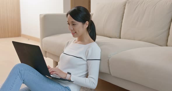 Woman type on computer at home