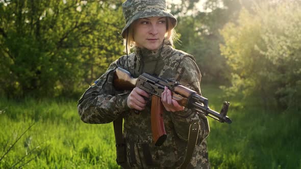 Ukrainian Female Soldier Armed with an Assault Rifle Patrols a Combat Zone