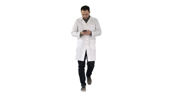 Doctor walking and writing a message on the phone on white