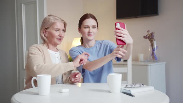 A Woman and Her Elderly Mother Pose for a Selfie