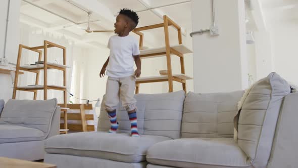 Young boy bouncing on couch