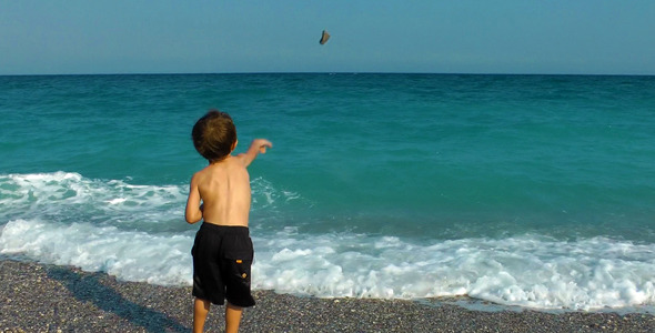 Boy Throwing Stones To The Sea 2