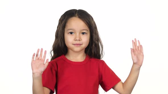 Little Girl Waving with Hands on White Background. Slow Motion