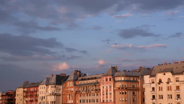 Clouds moving above old town at sunset