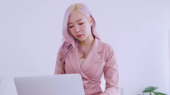 Asian secretary woman serious work from home on internet control laptop