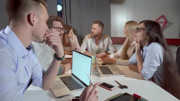 Men and Women Workers Are Making Brainstorming in Office Room