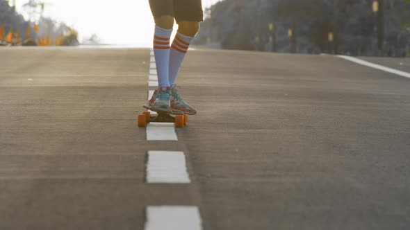 Portrait Boy with a Longboard on a Beautiful Road