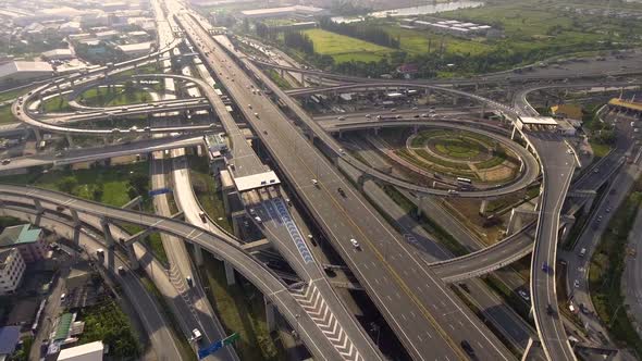 Aerial View of Highway Road Interchange with Busy Urban Traffic Speeding on Road