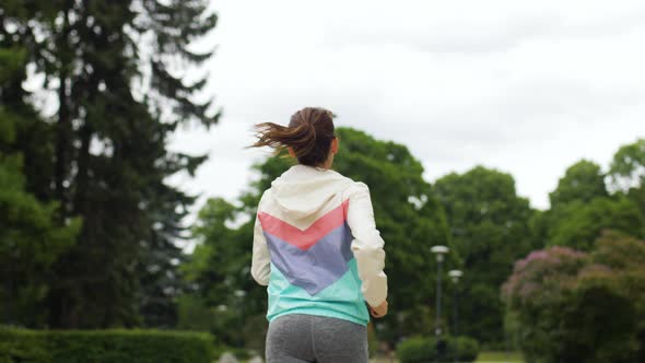 Smiling Woman Running Along Park 49