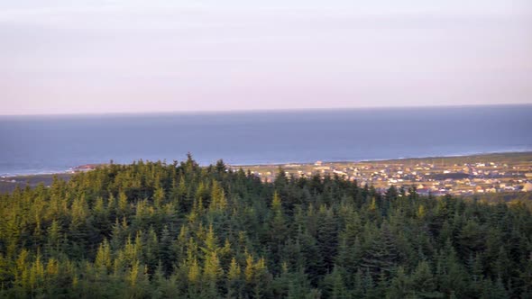 High angle sunset view of a small Magdalen Islands town at sunset. Beautiful serene evening sky over