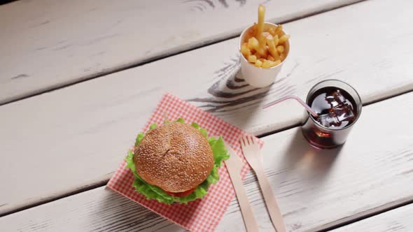 Hamburger with Cutlery and Drink.