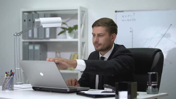 Male Boss Finishing Work on Laptop, Standing Up and Feeling Strong Pain in Back