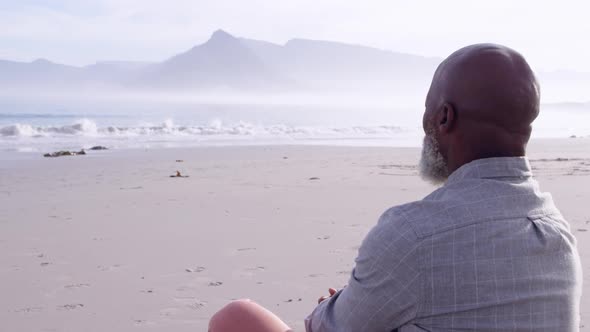 Mature man enjoying time outside by the sea