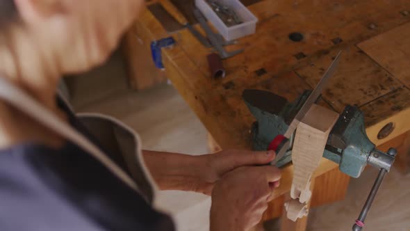 Female luthier at work in her workshop