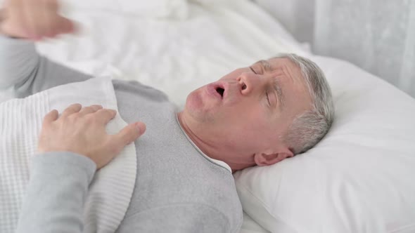 Sick Senior Old Man Sleeping in Bed and Coughing