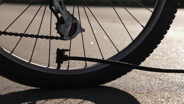 Man Inflating Bike Tire Outdoors