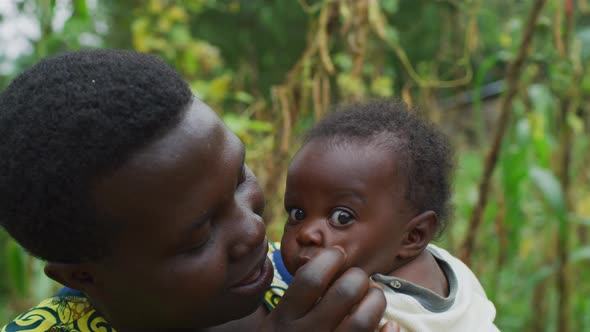 Mother holding and playing with her baby