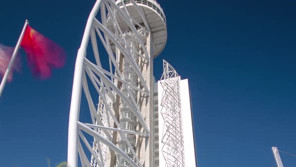 Hotel Tower with Palms and Flags in the Park of the Nations Timelapse Hyperlapse