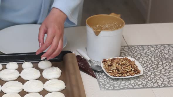 A Woman Checks The Quality Of The Meringue. Baking Tray With Meringue For Cake