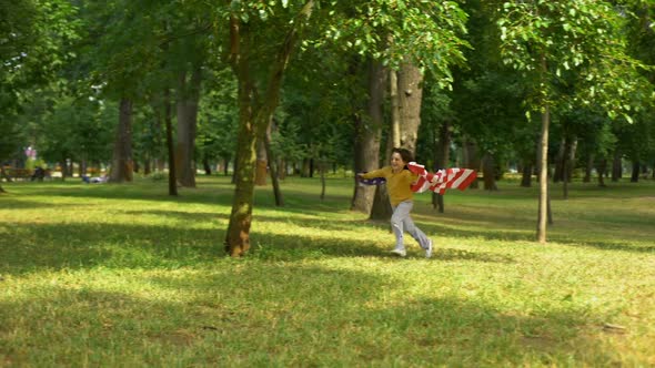 Boy With American Flag Running in Park, Independence Day Celebration, Future