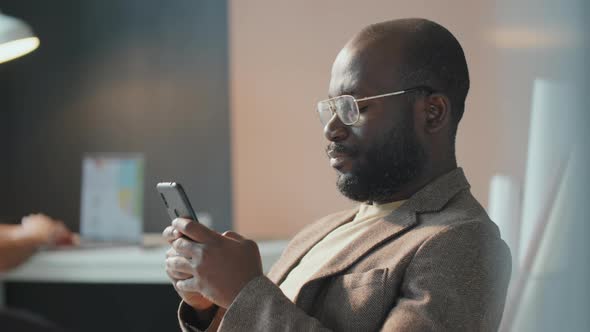 Man Surfing Internet On Smartphone