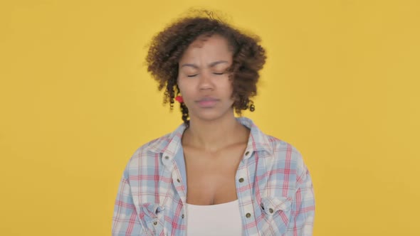 Young African Woman Showing No Sign By Finger on Yellow Background