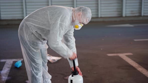 Man Dressed White Protective Overalls Spraying Surface Antibacterial Sanitizer Sprayer During