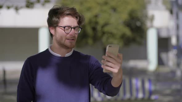 Happy Man Talking By Smartphone on Street