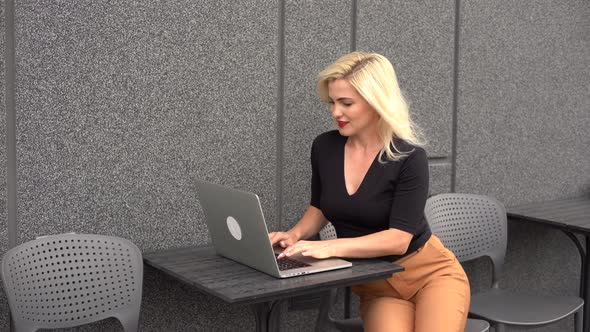 Young Woman Wearing Smartwatch Using Laptop Computer