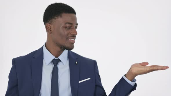 African Businessman Showing Product in Hand on White Background