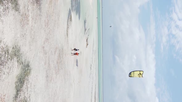 Vertical Video Kitesurfing Near the Shore of Zanzibar Tanzania Aerial View