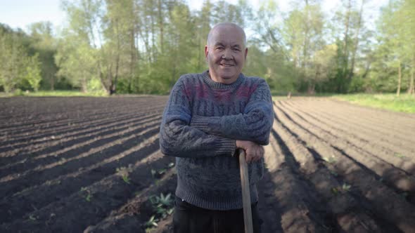 Portrait of a Happy Elderly Farmer After Working in the Field