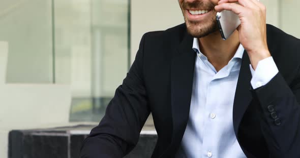 Businessman talking on mobile phone in stairs 4k