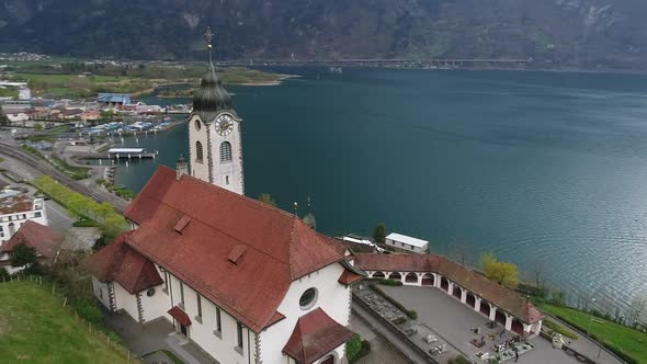 Aerial video of the Fluelen church in the Uri Canton of Switzerland during spring 