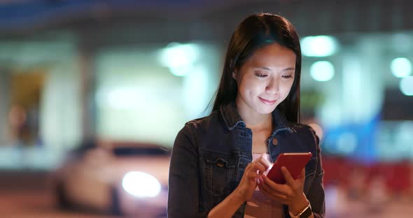 Woman Use of Mobile Phone in City at Night