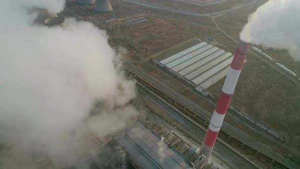 Aerial Drone View of Tall Chimney Pipes with Grey Smoke From Coal Power Plant