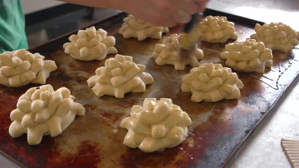 Female Chef Glazing Dough with Yolk