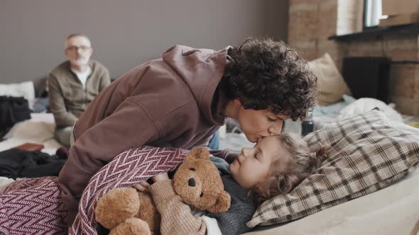 Mom Kissing Son Goodbye in Refuge