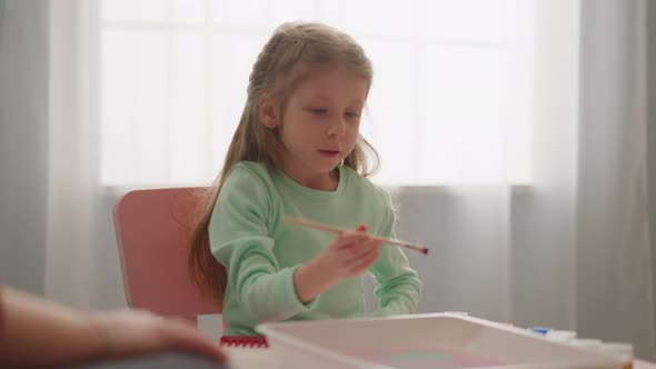 Concentrated Girl Drips Paint Into Liquid Doing Ebru Art