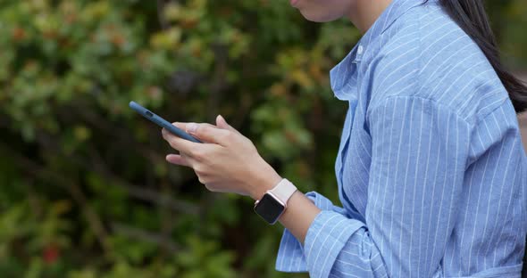 Woman use of mobile phone in the park