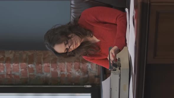 Woman Working at Desk with Vintage Typewriter