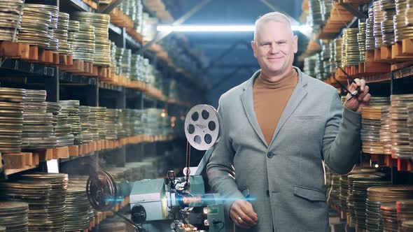 Male Specialist Is Smiling in the Film Archive