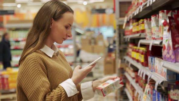 Woman Scans Information From the Barcode of a Tomato Jar Using Her Smartphone