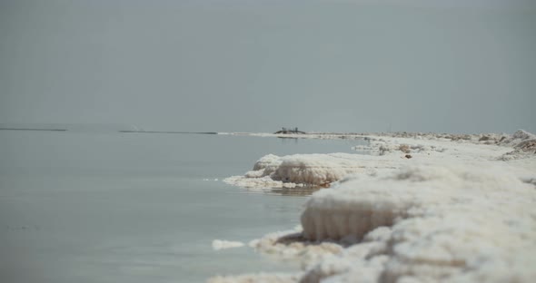 Tracking shot of salt deposits on the banks of the Dead Sea in israel