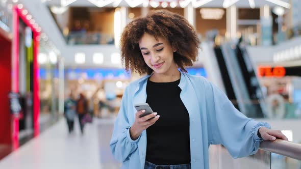 Young Girl African American Woman Customer Blogger Girlfriend Standing in Shopping Mall Looking at