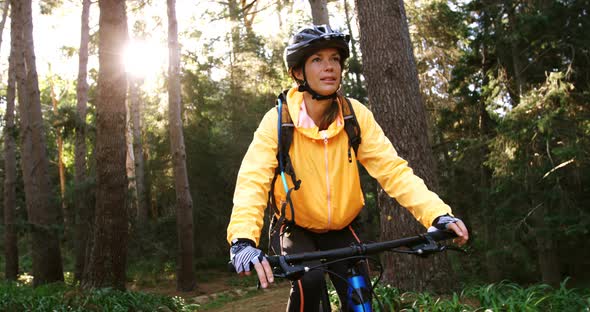 Female mountain biker riding in the forest