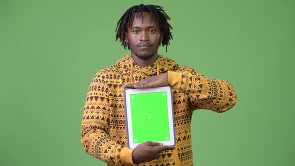 Young Handsome African Man Showing Digital Tablet