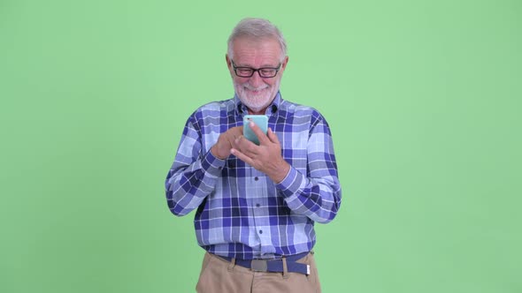 Happy Senior Bearded Hipster Man Using Phone