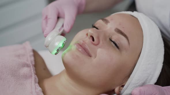 Young Woman Having Relaxing During Laser Rejuvenation of Face Skin in the Salon